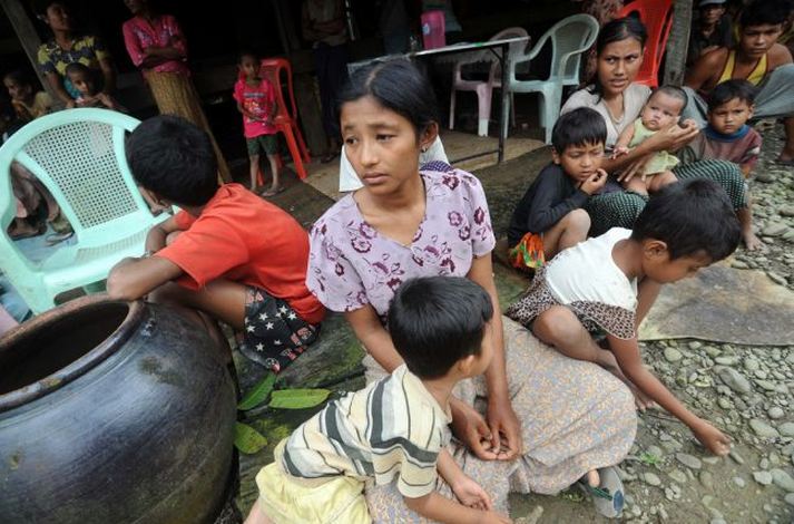 Muslim residents take shelter at a house in Thabyu Chai village near Thandwe, in Myanmar's western Rakhine state on October 2, 2013. Terrified women and children hid in forests and security forces patrolled tense villages in western Myanmar as police said the toll from fresh anti-Muslim unrest rose to five. Soe Than Win AFP/Getty Images