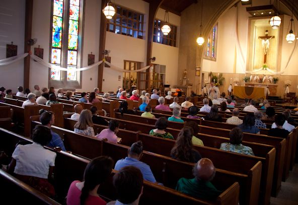 Parishioners listen to the homily during Catholic Mass at St. Therese Little Flower parish in Kansas City, Mo., on Sunday, May 20, 2012. RNS photo by Sally Morrow