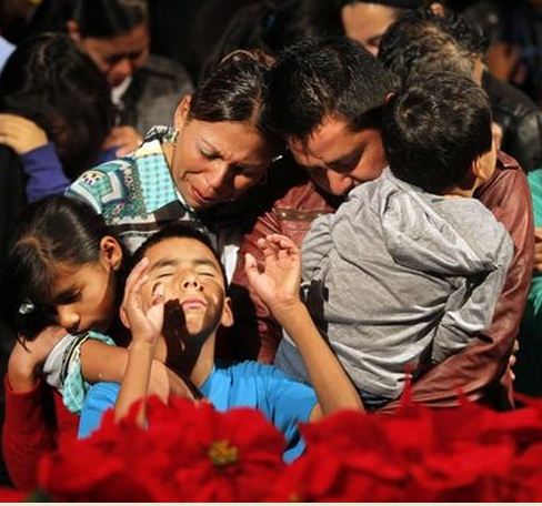 Families gather together in prayer at Restauracion Los Angeles Pentecostal church. Pastor Rene Molina founded the church in the late '80s and has presided over the creation of dozens of "daughter churches" throughout the country. (Allen J. Schaben / Los Angeles Times /December 8, 2013)