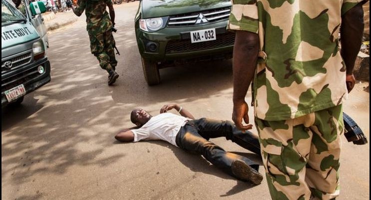 Nigerian Army forces man a checkpoint to protect Sunday Christian prayer services in Sokoto, Nigeria on April 14, 2013, where less than 5 percent of the population is Christian. (Ed Kashi/VII/GlobalPost)