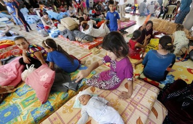 Iraqi Christian families at a community center in Erbil, June 27, 2014. (Karim Sahib/AFP/Getty Images)